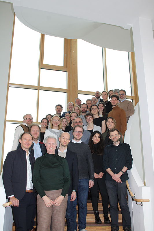 Group photo, approx. 30 people on a staircase